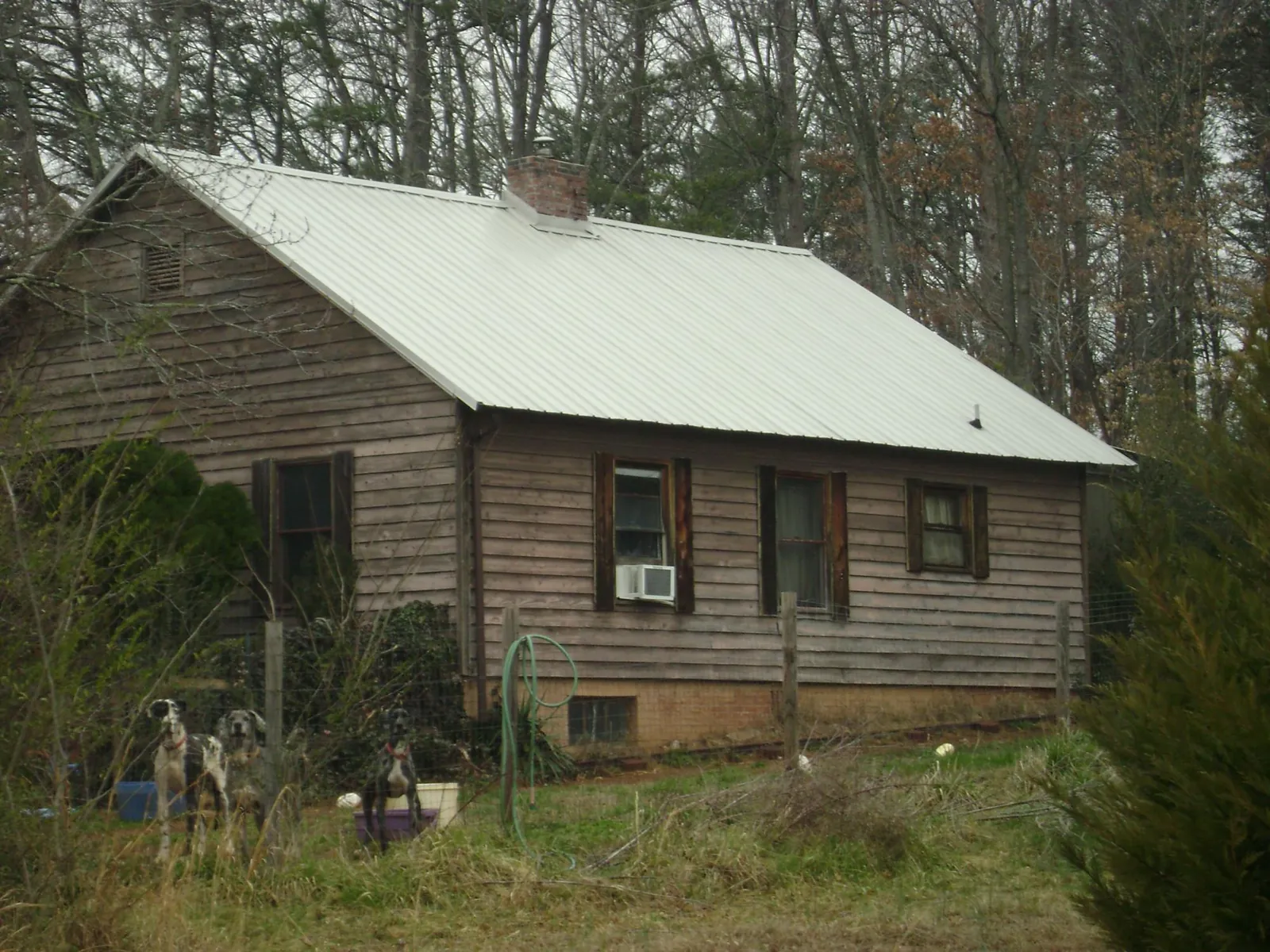 White metal roof on an old wood sided farmhouse, from a Metal Roof Installation job in Collegedale